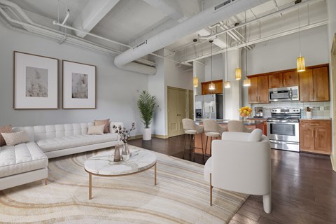 a living room with a white couch and a table at 100 South Apartments, Buffalo, New York